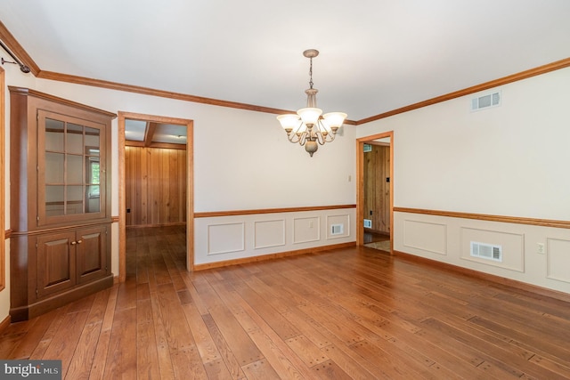 4 Apple Tree Ln, Hummelstown, PA 17036 - empty room with a chandelier, light wood-style flooring, crown molding, and wainscoting