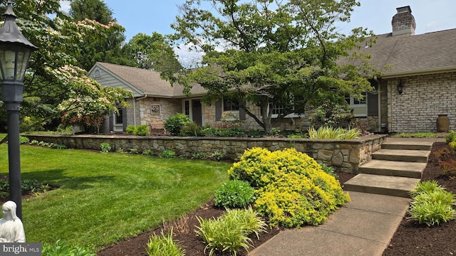 4 Apple Tree Ln, Hummelstown, PA 17036 - view of front of home with stone siding, a front yard, a chimney, and roof with shingles