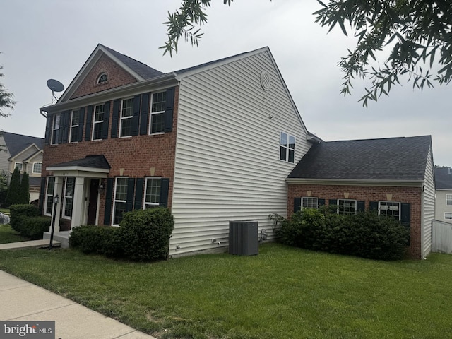 16874 Reef Knot Way, Woodbridge, VA 22191 - view of side of home with brick siding, cooling unit, and a yard