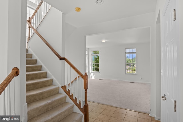 16874 Reef Knot Way, Woodbridge, VA 22191 - staircase with carpet floors, tile patterned flooring, and baseboards
