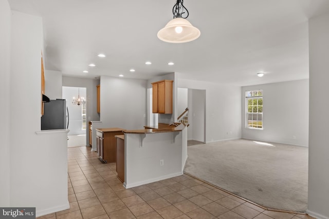 16874 Reef Knot Way, Woodbridge, VA 22191 - kitchen featuring freestanding refrigerator, light colored carpet, a kitchen breakfast bar, a peninsula, and recessed lighting