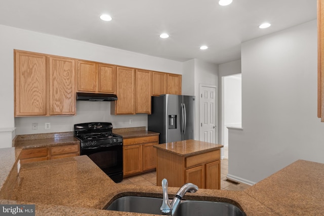 16874 Reef Knot Way, Woodbridge, VA 22191 - kitchen with black gas stove, stainless steel refrigerator with ice dispenser, a sink, under cabinet range hood, and recessed lighting