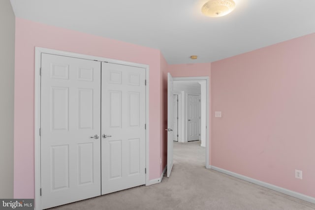16874 Reef Knot Way, Woodbridge, VA 22191 - unfurnished bedroom with light carpet, baseboards, and a closet