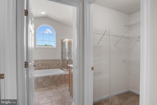 16874 Reef Knot Way, Woodbridge, VA 22191 - full bathroom with a bath, tile patterned floors, lofted ceiling, and a spacious closet