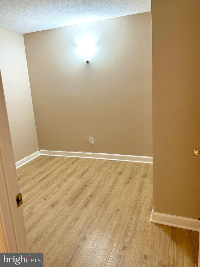 1836 Metzerott Rd Unit 1414, Adelphi, MD 20783 - empty room with light wood-style floors, baseboards, and a textured ceiling