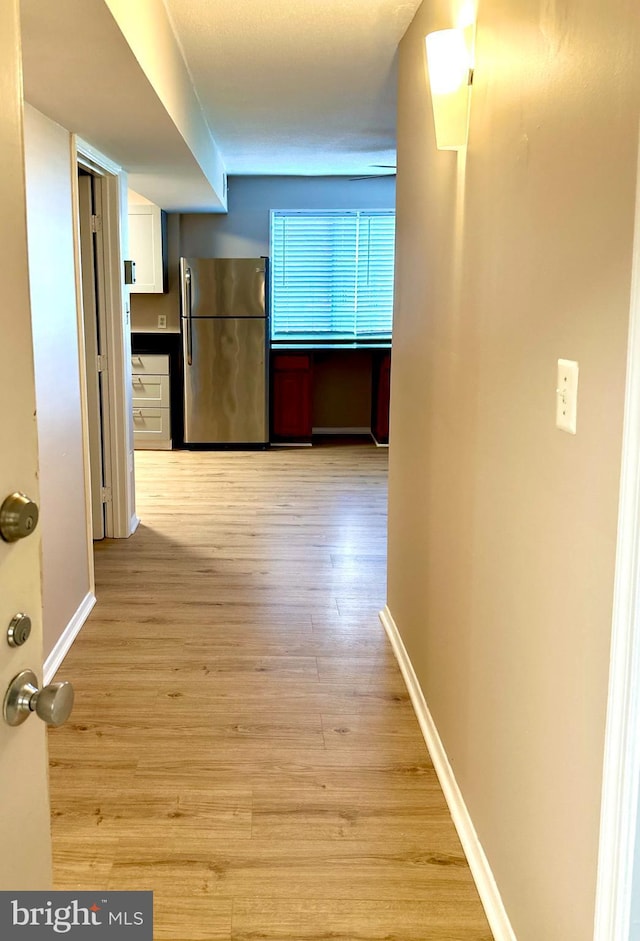 1836 Metzerott Rd Unit 1414, Adelphi, MD 20783 - hall featuring light wood-style flooring and baseboards