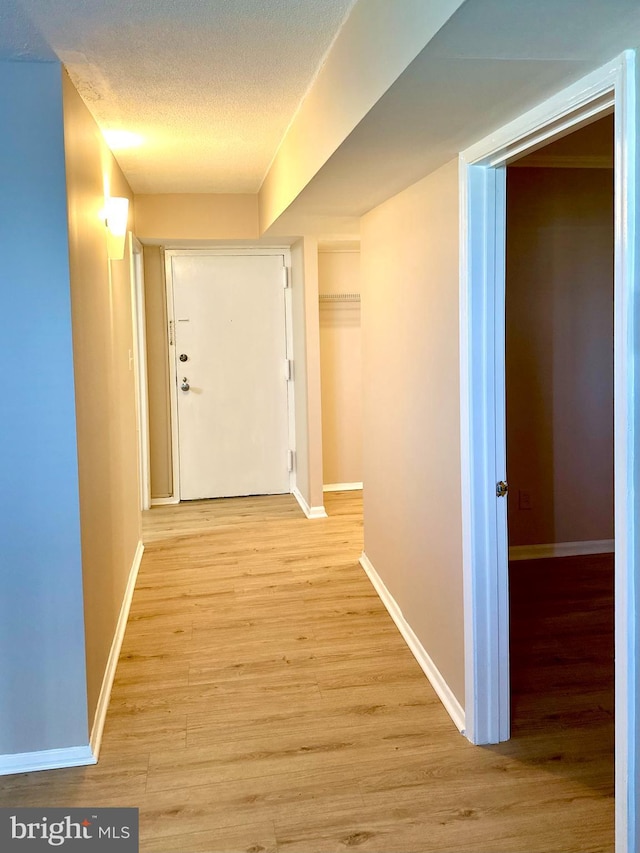 1836 Metzerott Rd Unit 1414, Adelphi, MD 20783 - corridor with light wood-style floors, baseboards, and a textured ceiling