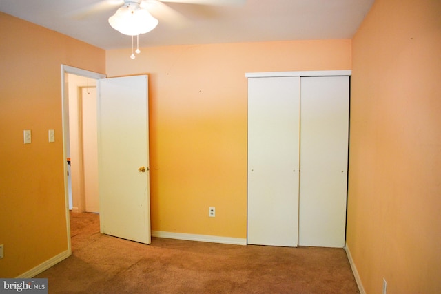 unfurnished bedroom featuring carpet, a closet, and baseboards