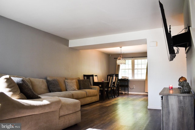 living area featuring dark wood-type flooring and baseboards