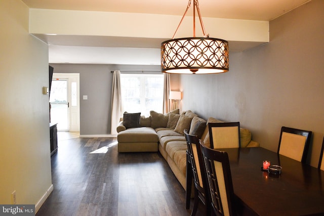 dining space with dark wood-type flooring and baseboards
