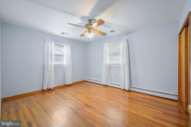 191 Harmony Rd, Gibbstown, NJ 08027 - empty room featuring a ceiling fan, wood finished floors, baseboard heating, and baseboards