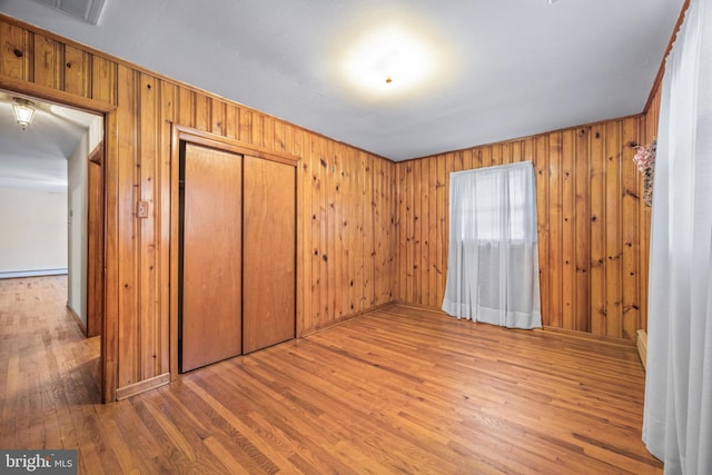 191 Harmony Rd, Gibbstown, NJ 08027 - unfurnished bedroom with wood finished floors, a closet, and wood walls