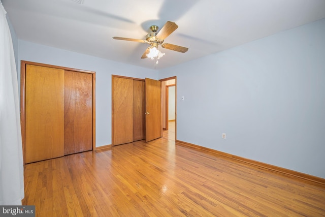 191 Harmony Rd, Gibbstown, NJ 08027 - unfurnished bedroom featuring multiple closets, light wood-style flooring, baseboards, and a ceiling fan