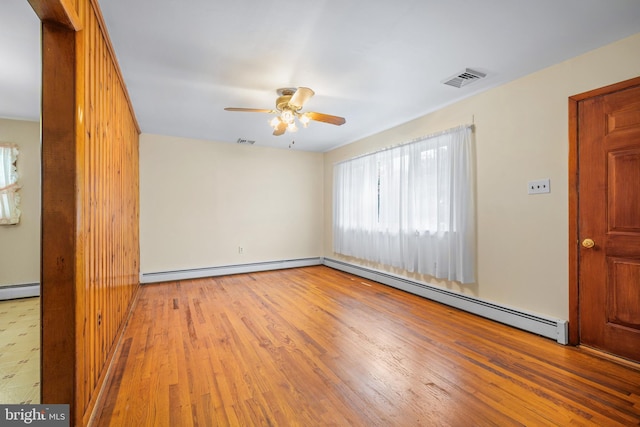 191 Harmony Rd, Gibbstown, NJ 08027 - empty room featuring plenty of natural light, a baseboard heating unit, ceiling fan, and wood finished floors