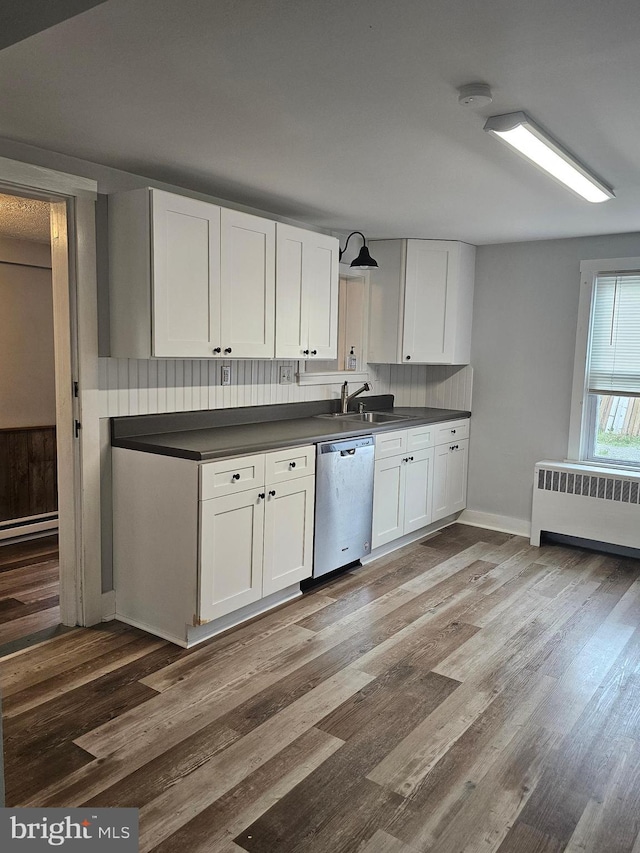 10992 Roxbury Rd, Orrstown, PA 17244 - kitchen featuring stainless steel dishwasher, radiator, a sink, dark countertops, and white cabinetry