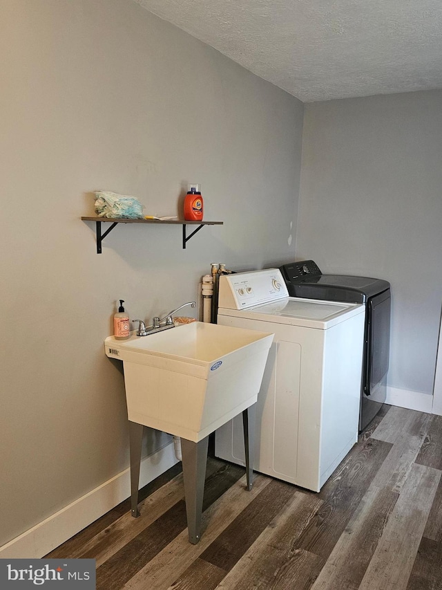10992 Roxbury Rd, Orrstown, PA 17244 - laundry room featuring independent washer and dryer, dark wood-style flooring, a textured ceiling, and baseboards