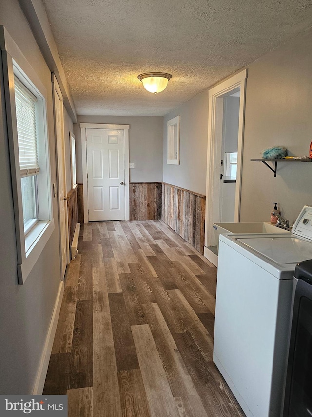 10992 Roxbury Rd, Orrstown, PA 17244 - washroom featuring wood finished floors, a textured ceiling, a wainscoted wall, wooden walls, and washer and dryer