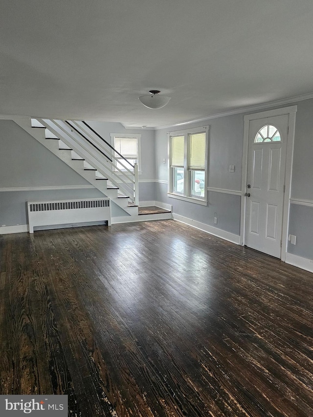 10992 Roxbury Rd, Orrstown, PA 17244 - unfurnished living room featuring radiator heating unit, stairway, wood finished floors, plenty of natural light, and crown molding