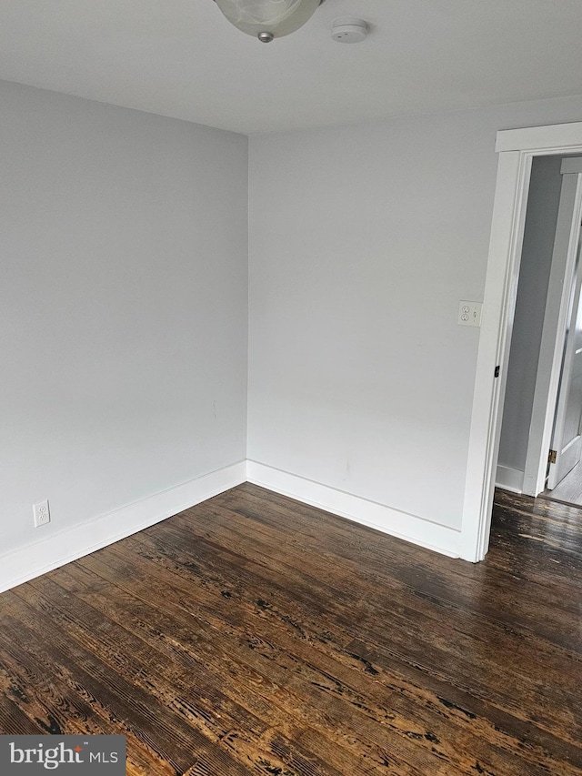 10992 Roxbury Rd, Orrstown, PA 17244 - empty room with dark wood-type flooring, a smoke detector, and baseboards
