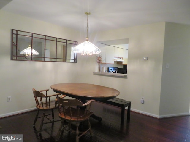 dining space featuring wood finished floors and baseboards