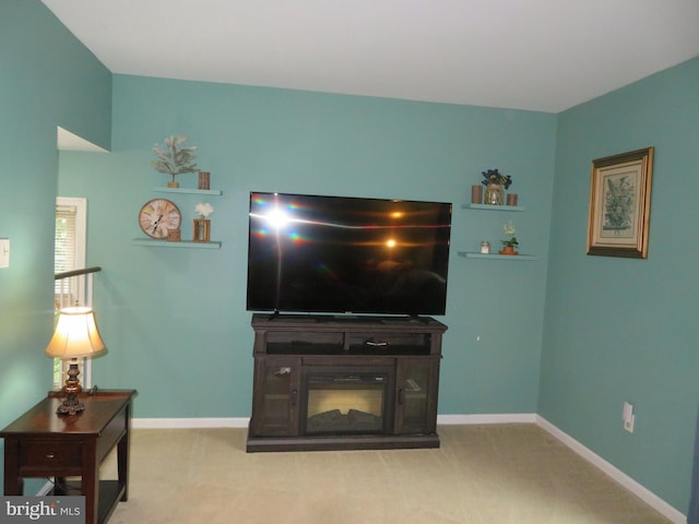 carpeted living room featuring baseboards