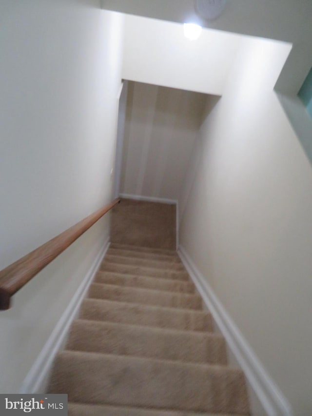 stairs with carpet flooring and baseboards