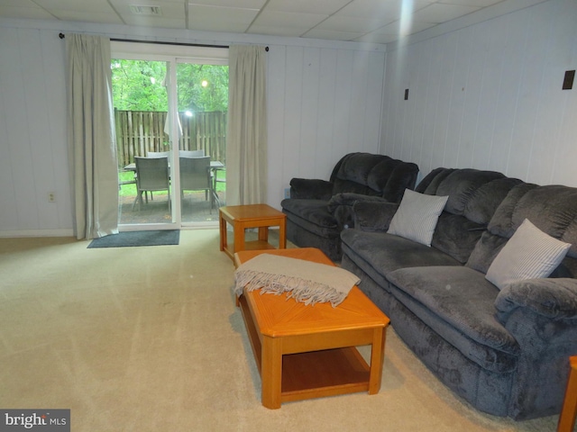 living room with carpet and wooden walls