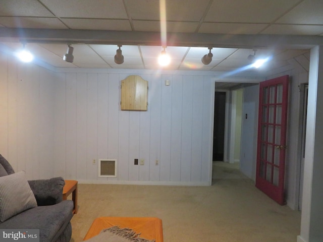 finished below grade area featuring carpet floors and rail lighting