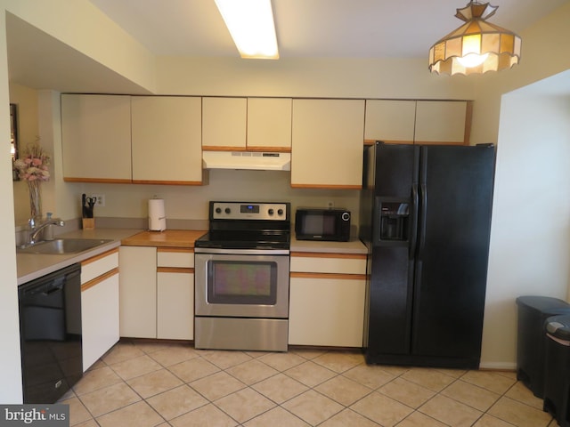 kitchen with black appliances, under cabinet range hood, a sink, light countertops, and light tile patterned floors
