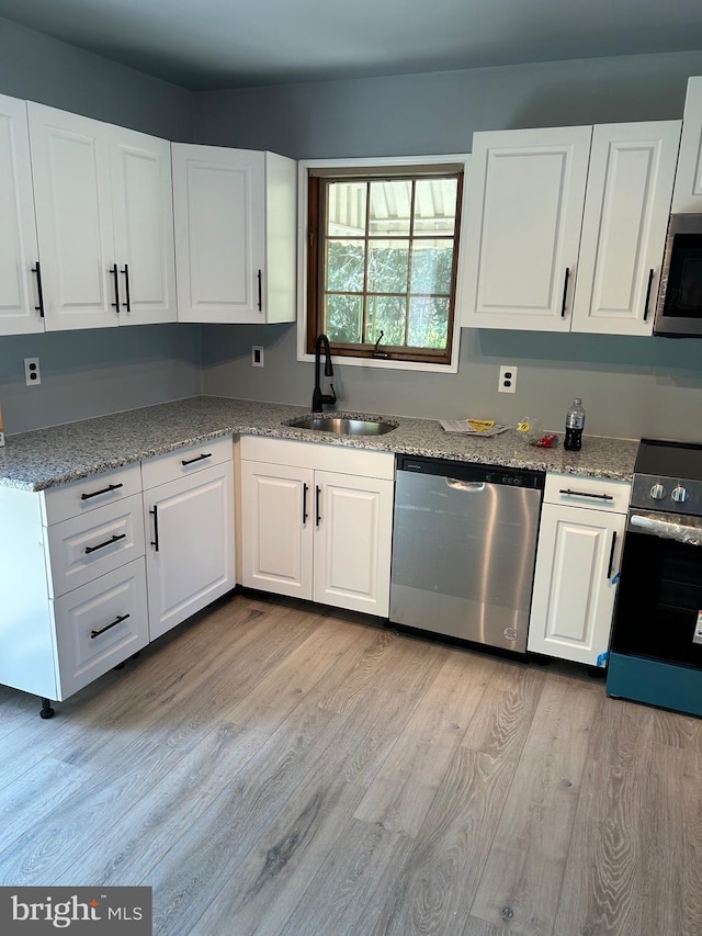 125 E Elm Ave, Lindenwold, NJ 08021 - kitchen with appliances with stainless steel finishes, a sink, light wood-style flooring, and white cabinetry