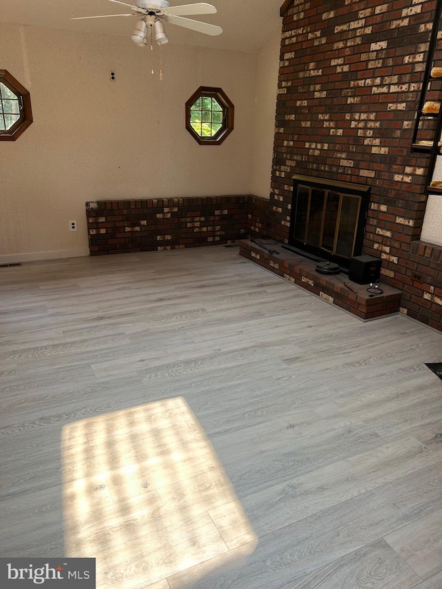 125 E Elm Ave, Lindenwold, NJ 08021 - unfurnished living room with wood finished floors, a brick fireplace, and a ceiling fan