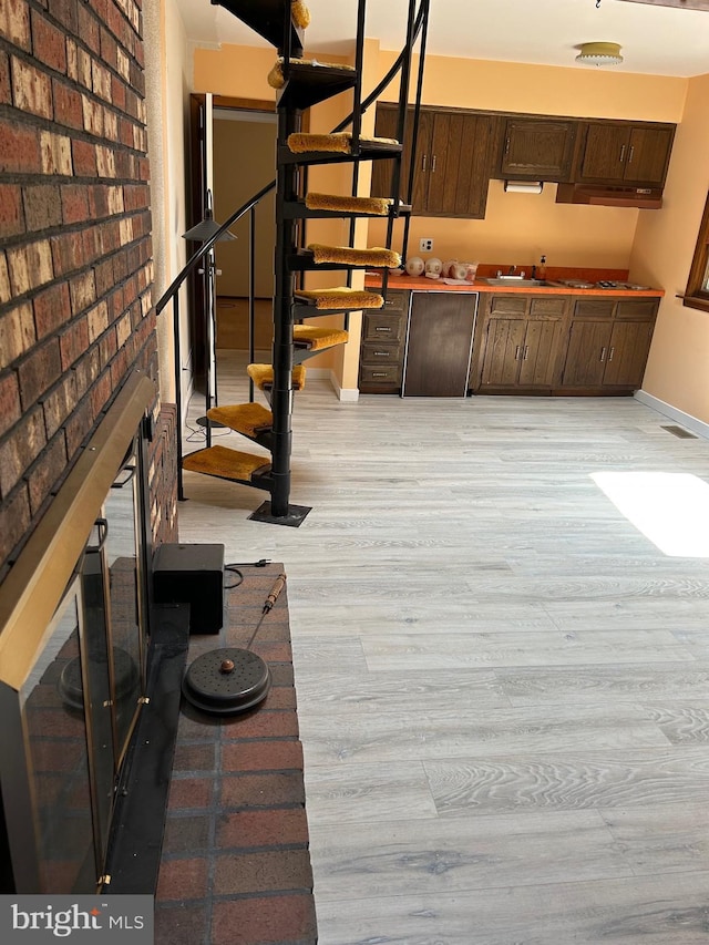 125 E Elm Ave, Lindenwold, NJ 08021 - unfurnished living room featuring stairway, light wood-type flooring, a fireplace, and baseboards