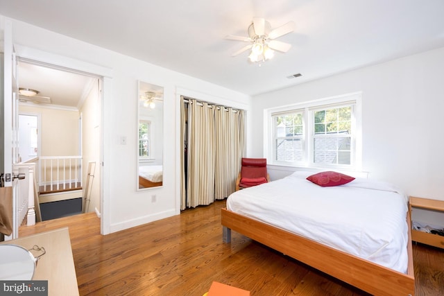 9841 Meadowcroft Ln, Montgomery Village, MD 20886 - bedroom with wood finished floors, baseboards, and a ceiling fan