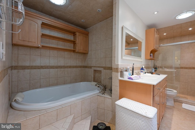 9841 Meadowcroft Ln, Montgomery Village, MD 20886 - bathroom with tile walls, tile patterned floors, vanity, toilet, and a garden tub