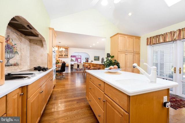 9841 Meadowcroft Ln, Montgomery Village, MD 20886 - kitchen with vaulted ceiling, a sink, light wood-style floors, arched walkways, and light countertops