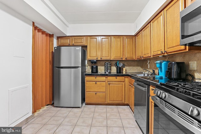10816 Green Mountain Cir Unit 19-10, Columbia, MD 21044 - kitchen with appliances with stainless steel finishes, dark countertops, backsplash, and brown cabinets