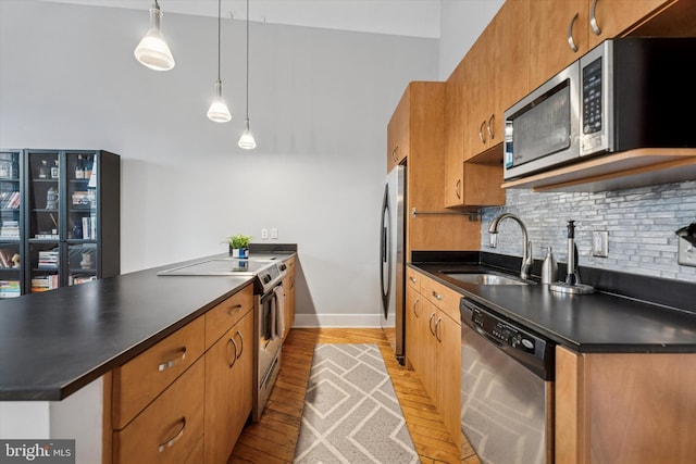 200 Lincoln Ave Unit 304, Phoenixville, PA 19460 - kitchen featuring appliances with stainless steel finishes, a sink, dark countertops, and light wood finished floors