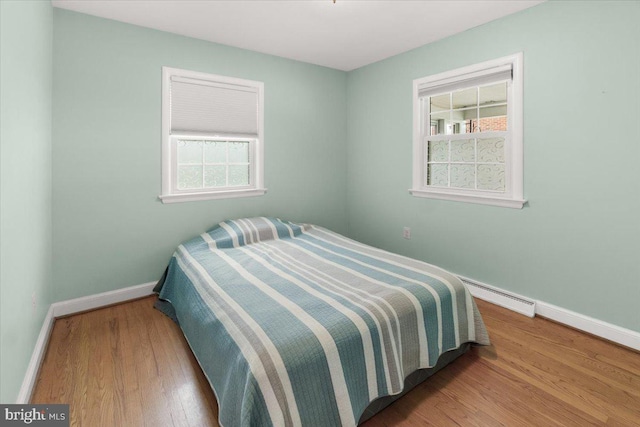 101 Flower, Mount Airy, MD 21771 - bedroom featuring a baseboard heating unit, baseboards, and wood finished floors