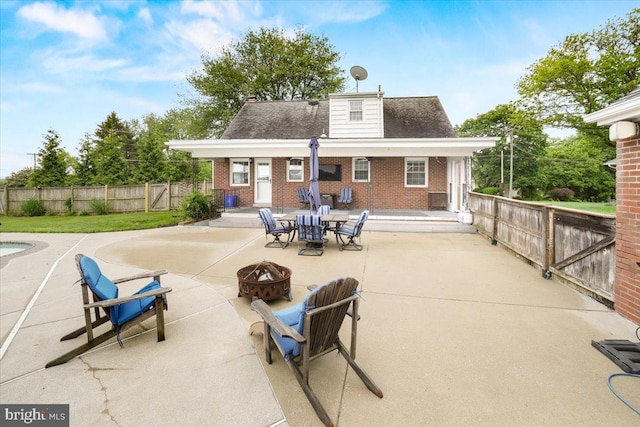 101 Flower, Mount Airy, MD 21771 - rear view of house featuring an outdoor fire pit, a patio, brick siding, and a fenced backyard