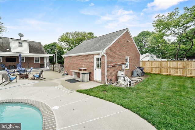101 Flower, Mount Airy, MD 21771 - rear view of house with brick siding, a fire pit, a patio area, and a shingled roof