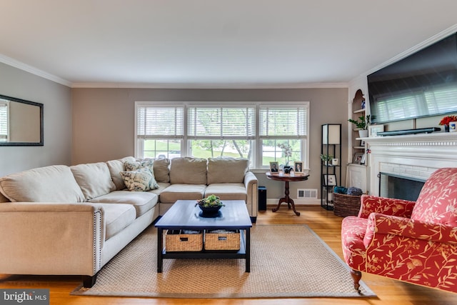 3663 Trinity, Alexandria, VA 22304 - living room featuring healthy amount of natural light, wood finished floors, ornamental molding, a brick fireplace, and baseboards