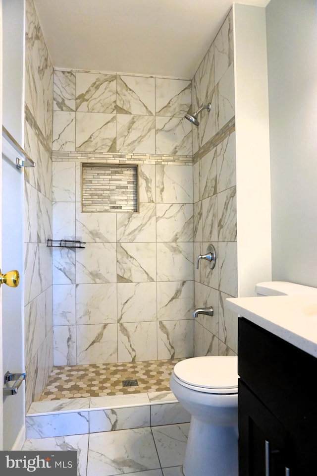 3506 Split Rail Ln, Ellicott City, MD 21042 - full bath featuring a tile shower, vanity, marble look tiles, and toilet