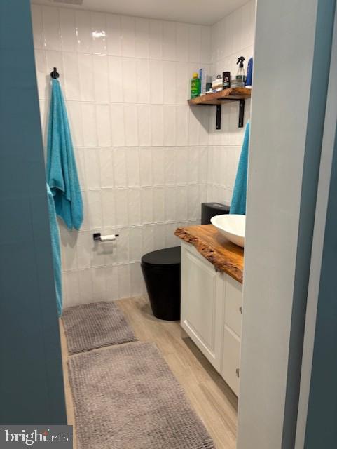 9415 Pacific Ave Unit 43, Margate City, NJ 08402 - bathroom with vanity, toilet, wood finished floors, and tile walls
