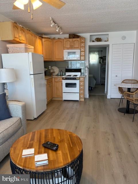 9415 Pacific Ave Unit 43, Margate City, NJ 08402 - kitchen with white appliances, track lighting, light wood-style floors, light countertops, and a ceiling fan