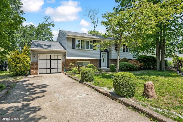 513 Louisiana Trl, Browns Mills, NJ 08015 - bi-level home with an attached garage, brick siding, driveway, and a front yard