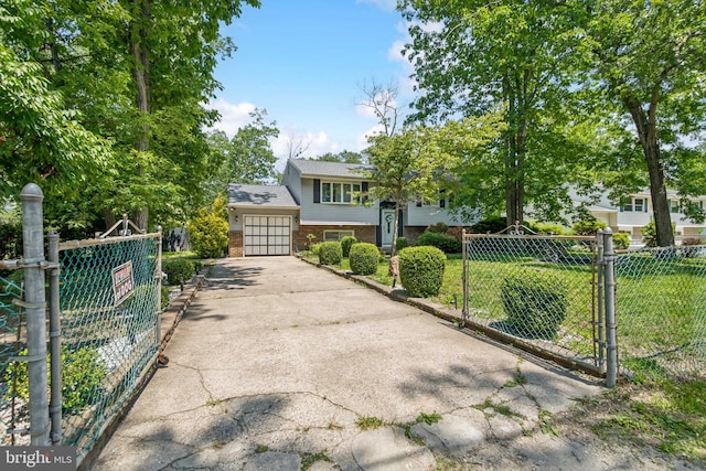 513 Louisiana Trl, Browns Mills, NJ 08015 - view of front of home with brick siding, a gate, driveway, and a garage
