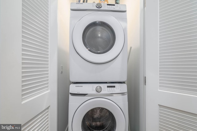 washroom featuring stacked washer / dryer