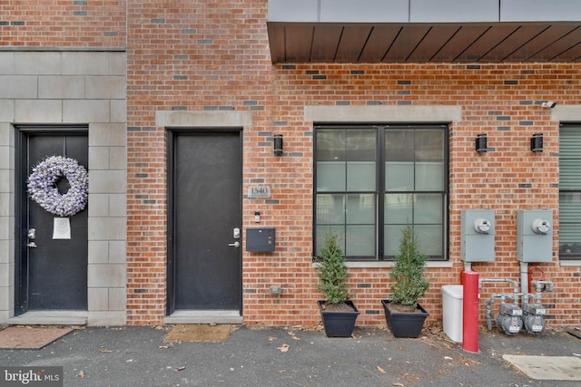 entrance to property featuring brick siding
