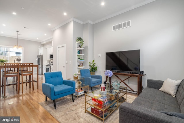living room with recessed lighting, light wood finished floors, and crown molding