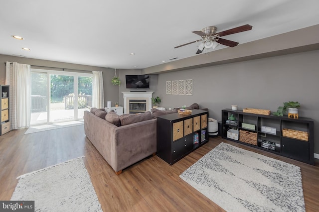 130 Brent Ct, Thorofare, NJ 08086 - living area with a glass covered fireplace, wood finished floors, a ceiling fan, and recessed lighting